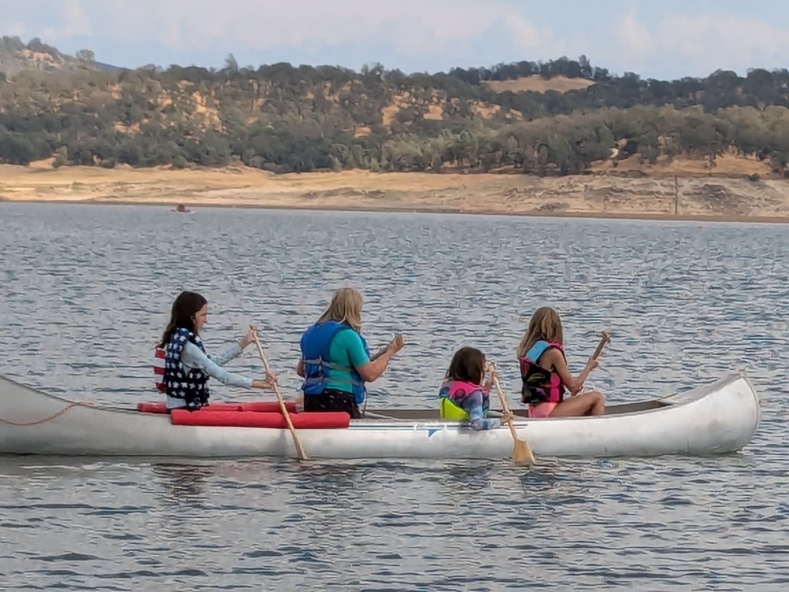 Students paddling a canoe together on a field trip